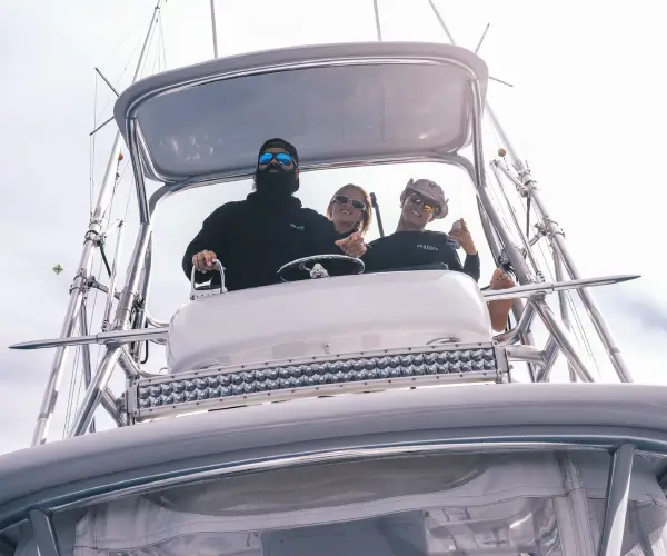 A group of anglers holding fish on a charter boat in North Miami