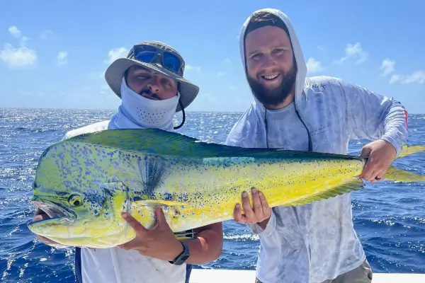 A person sitting on a boat with a fishing pole in Brickell