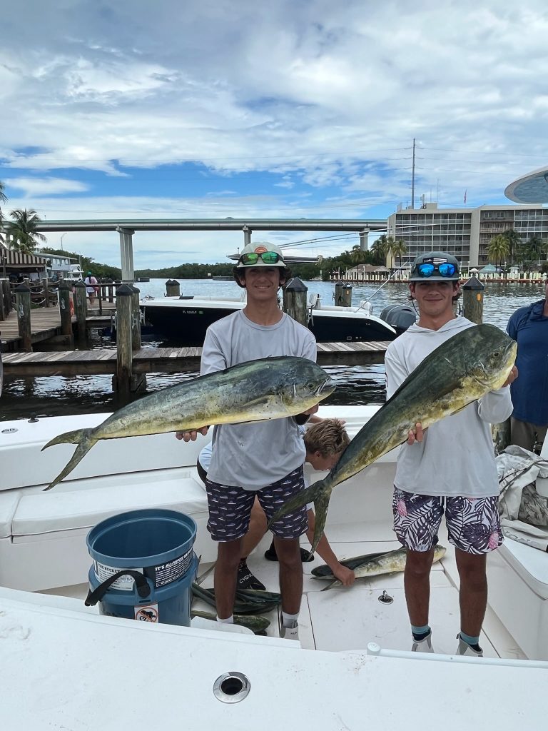 A group of men with fish on a boat in North Miami
