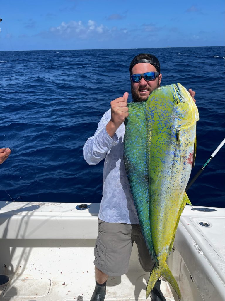 A person with a large fish on a boat in North Miami