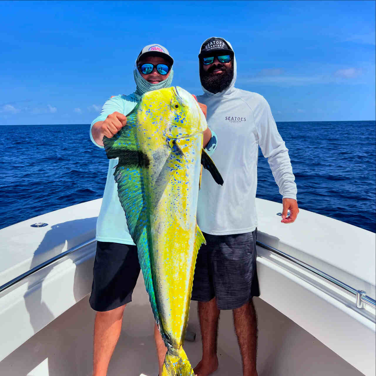 Two men displaying their catch on a boat in North Miami