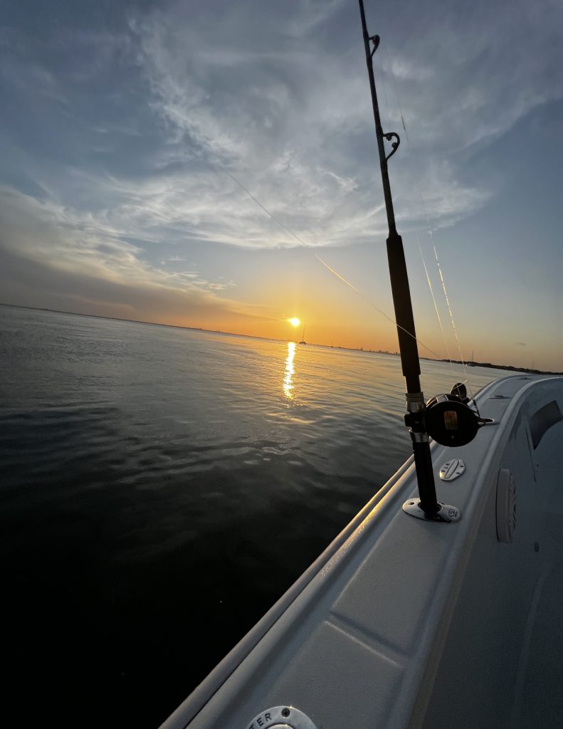 A fishing pole on a boat during a deep sea fishing tour