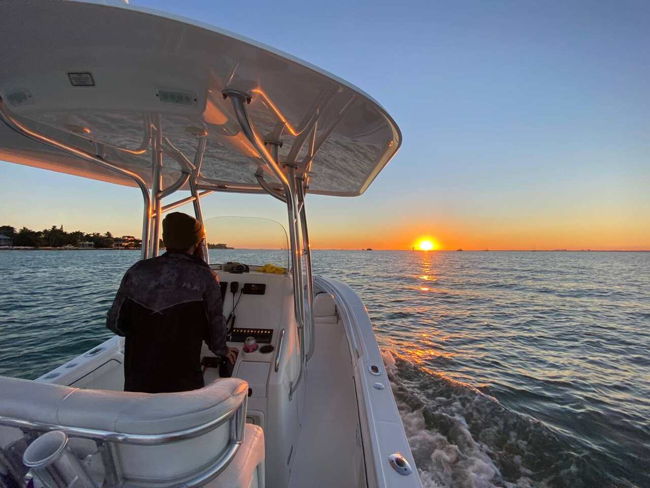 A person on a boat at sunset in North Miami